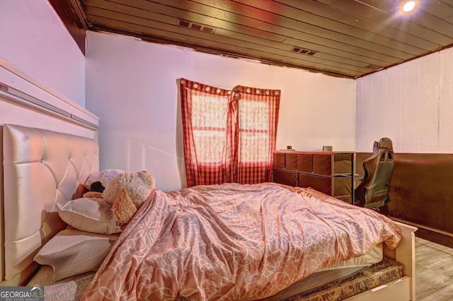 bedroom featuring wood ceiling and light wood-type flooring