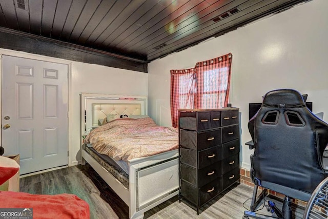 bedroom featuring hardwood / wood-style floors and wooden ceiling