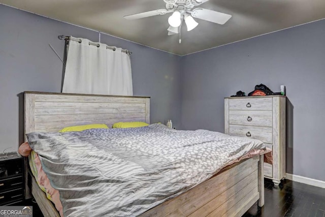 bedroom with ceiling fan and dark wood-type flooring