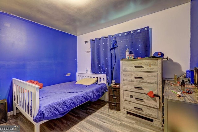 bedroom featuring wood-type flooring