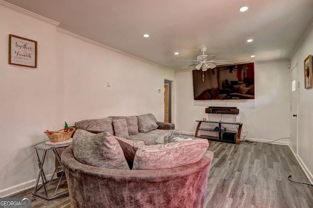 living room with hardwood / wood-style flooring, ceiling fan, and crown molding