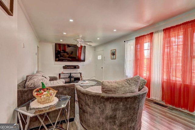 living room featuring hardwood / wood-style floors and ceiling fan