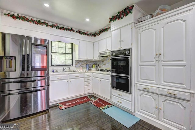 kitchen featuring backsplash, sink, white cabinetry, and stainless steel appliances