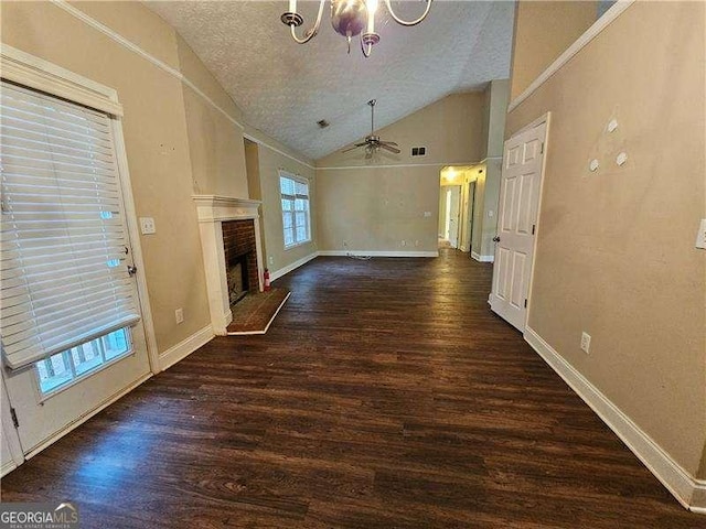 unfurnished living room featuring a brick fireplace, a textured ceiling, vaulted ceiling, and dark hardwood / wood-style flooring