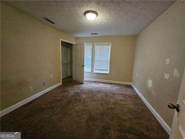 unfurnished bedroom featuring carpet flooring, a closet, and a textured ceiling