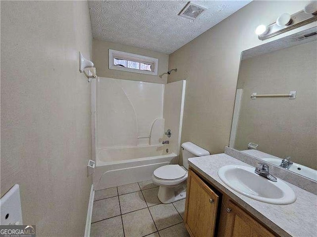 full bathroom featuring vanity, bathing tub / shower combination, tile patterned floors, toilet, and a textured ceiling