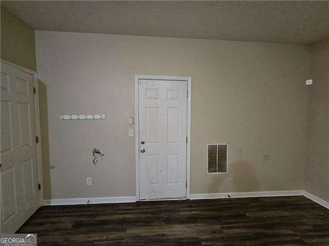 spare room with dark hardwood / wood-style flooring