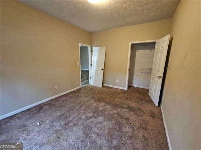 unfurnished bedroom with a textured ceiling