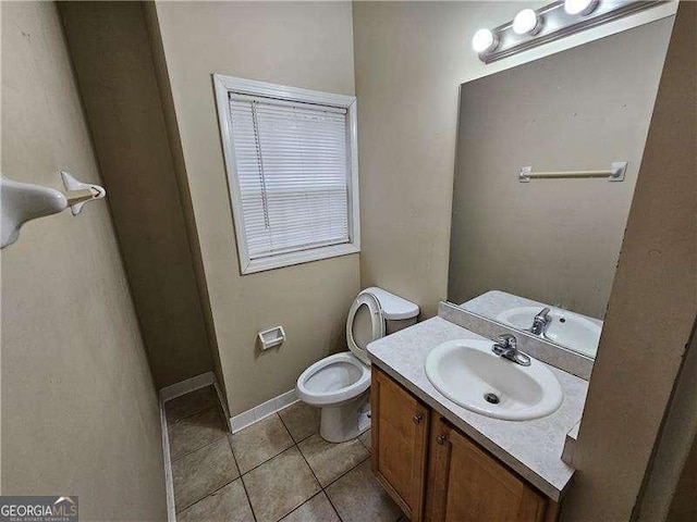 bathroom with tile patterned flooring, vanity, and toilet