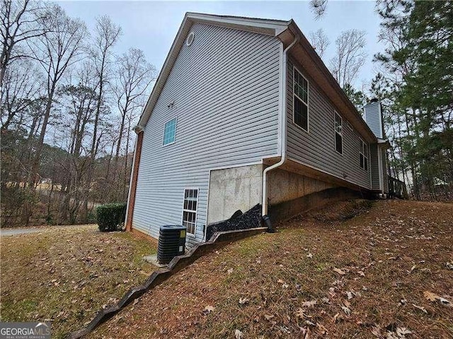 view of side of home featuring central AC unit