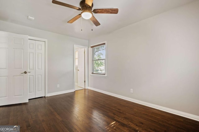 unfurnished bedroom featuring a closet, ceiling fan, and dark wood-type flooring