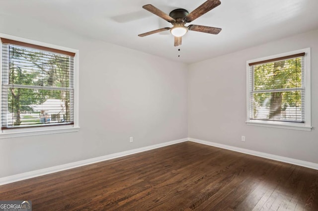 empty room featuring ceiling fan and dark hardwood / wood-style floors