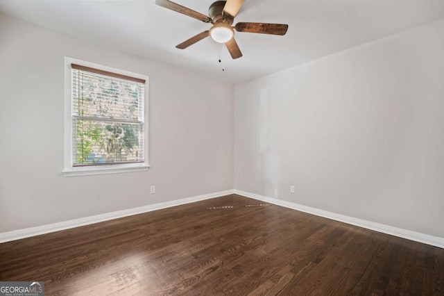 spare room featuring dark hardwood / wood-style flooring and ceiling fan