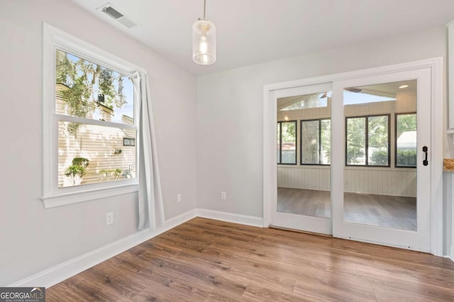 unfurnished room with hardwood / wood-style floors