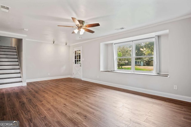 empty room featuring hardwood / wood-style flooring, ceiling fan, and ornamental molding