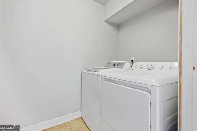 clothes washing area with independent washer and dryer and light tile patterned floors