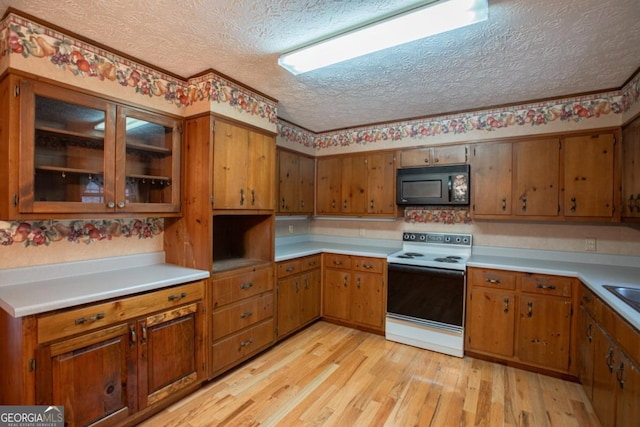 kitchen featuring white range with electric stovetop, light hardwood / wood-style floors, sink, and a textured ceiling