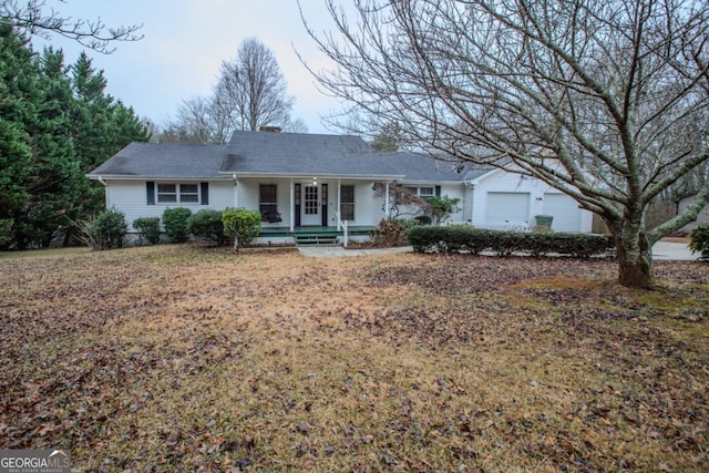 ranch-style home featuring a porch and a garage