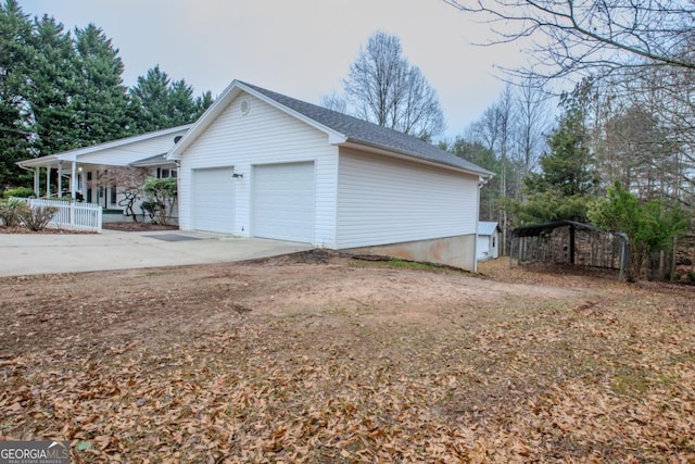 view of side of property featuring a porch and a garage