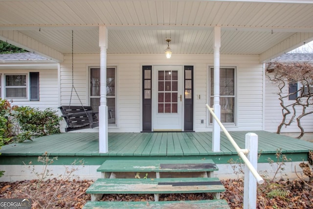 view of exterior entry with covered porch