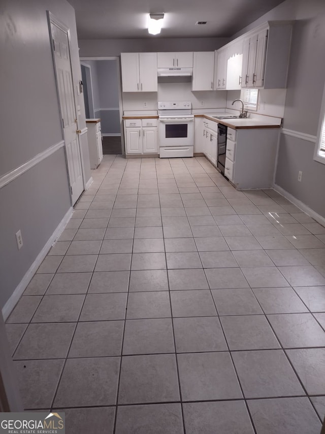 kitchen with white range with electric stovetop, sink, white cabinets, and light tile patterned floors