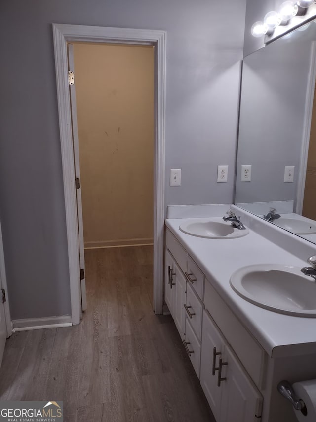 bathroom with vanity and hardwood / wood-style flooring