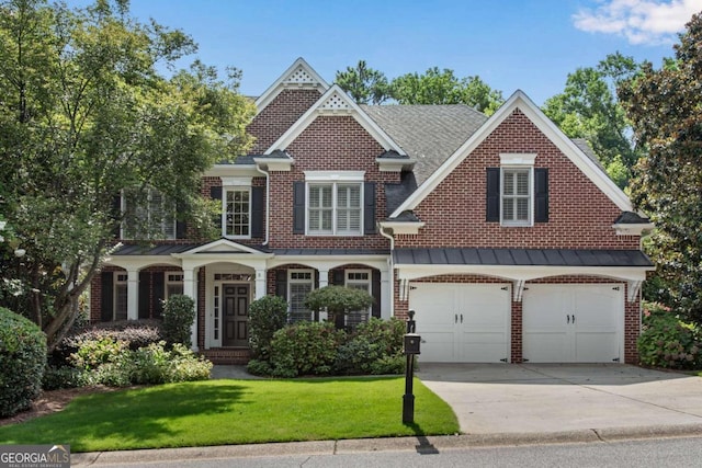 view of front of property with a front yard and a garage