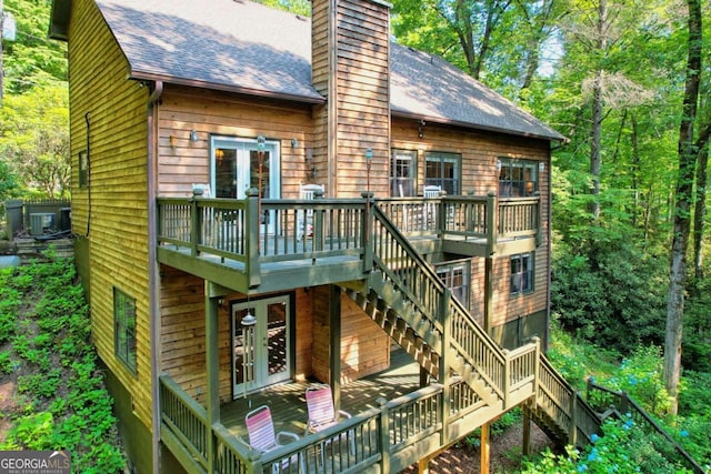 back of property featuring a wooden deck and french doors