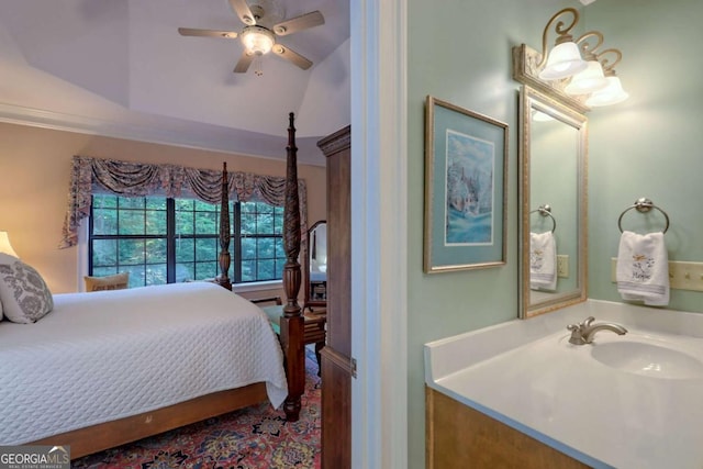 bedroom featuring a raised ceiling, ceiling fan, and sink