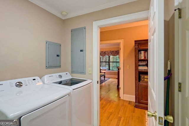 washroom with electric panel, separate washer and dryer, crown molding, and light hardwood / wood-style flooring