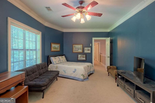 bedroom featuring ceiling fan, crown molding, and light carpet