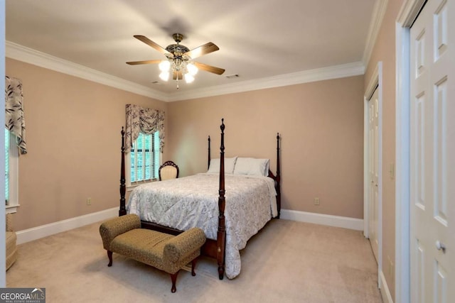 carpeted bedroom featuring ceiling fan and crown molding