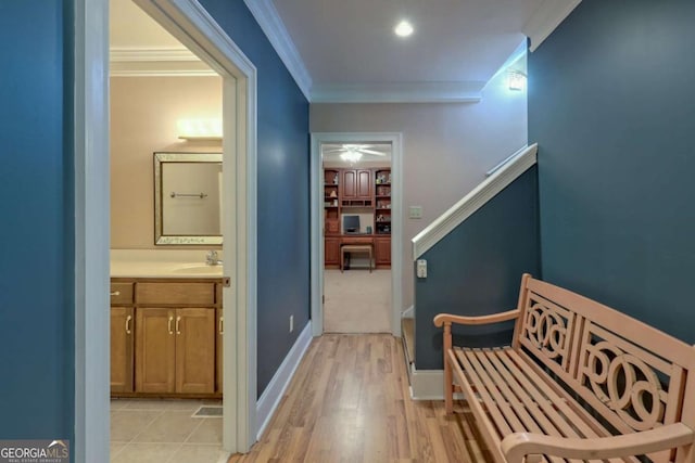 hallway with crown molding and sink