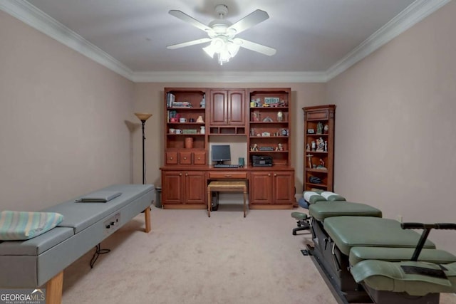 office space featuring light colored carpet, ceiling fan, and ornamental molding