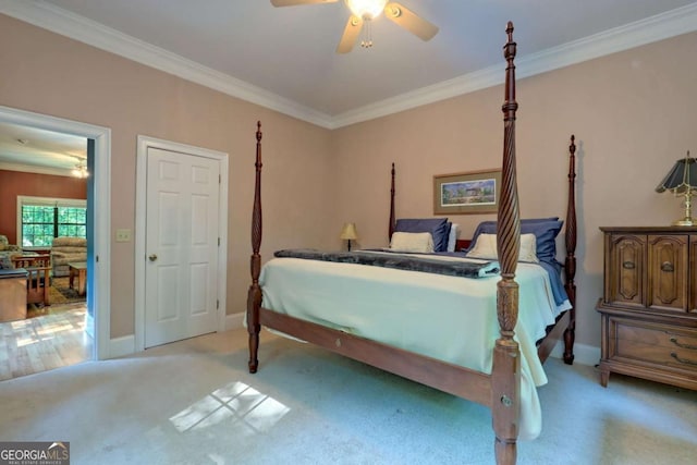 bedroom featuring ceiling fan, light colored carpet, and ornamental molding