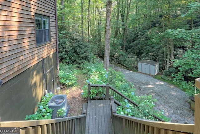 view of yard featuring a shed and a deck