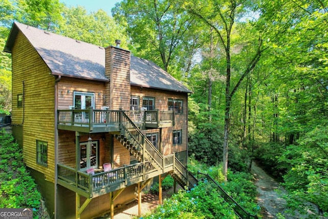 back of house featuring french doors, central AC unit, and a deck