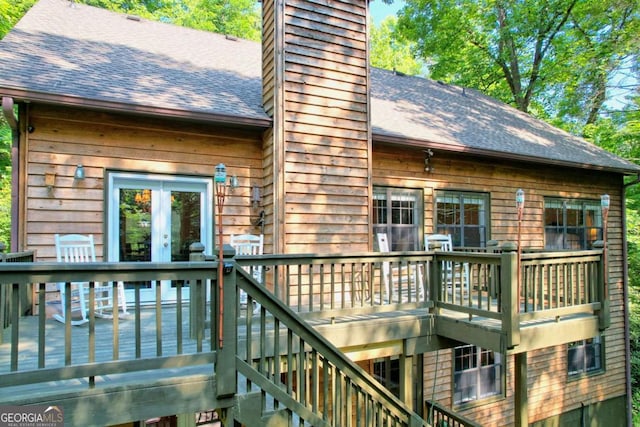 back of property featuring a wooden deck