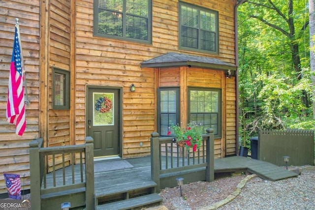 view of exterior entry featuring covered porch