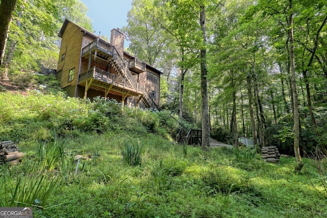 back of property featuring a wooden deck