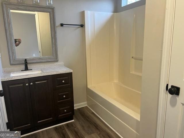 bathroom featuring shower / bathing tub combination, vanity, and hardwood / wood-style floors