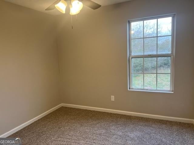 spare room with ceiling fan and carpet floors