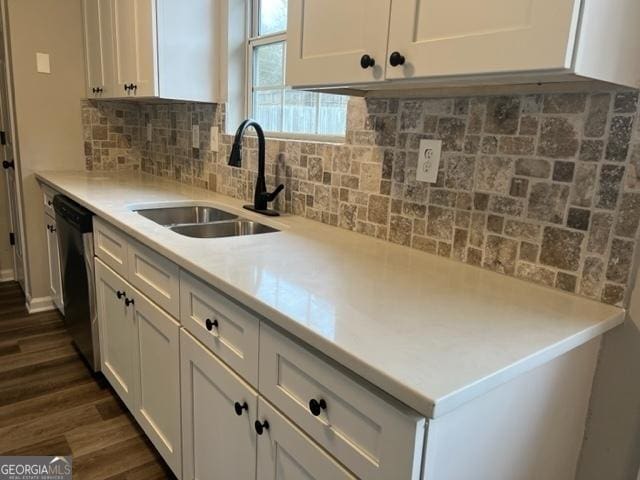 kitchen with dishwasher, dark hardwood / wood-style floors, decorative backsplash, sink, and white cabinets