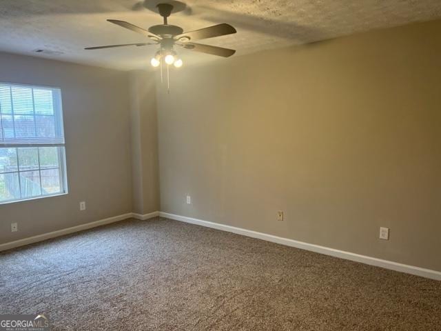 carpeted empty room featuring a textured ceiling and ceiling fan