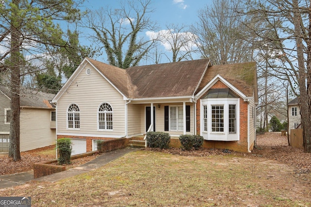 view of front of property with a front yard and a garage