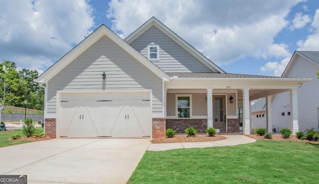 view of front of home with a porch, a garage, and a front yard