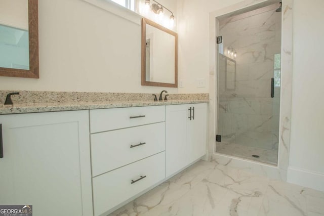 bathroom with vanity and a shower with shower door