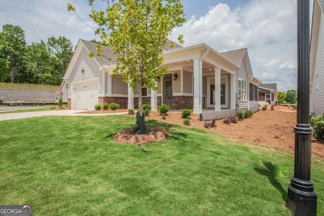 view of front of house featuring a porch, a garage, and a front lawn