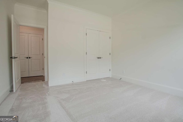 carpeted spare room with crown molding