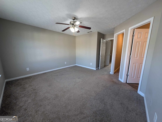 carpeted empty room featuring a textured ceiling and ceiling fan